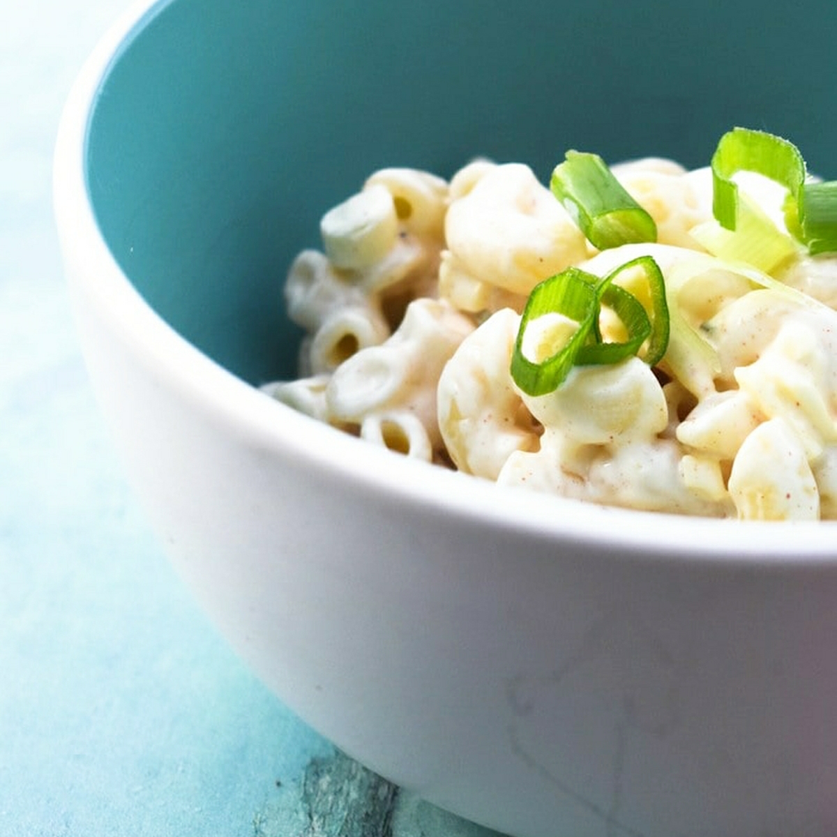 Vegan cheesy pasta salad in a blue bowl