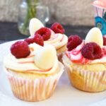 Raspberry white chocolate cupcakes topped with fresh raspberries