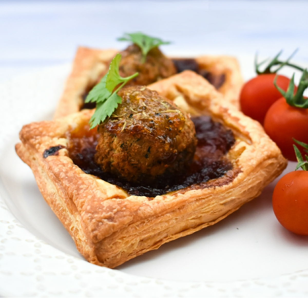 A square falafel onion pie with cherry tomatoes.