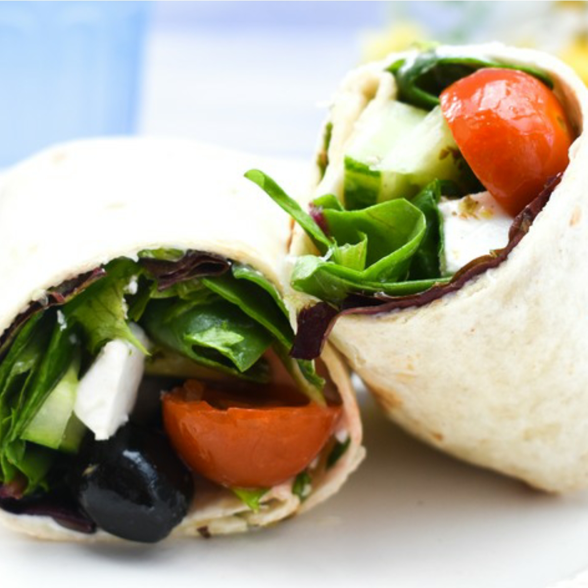 Vegan Greek Salad Lunch Wrap on a white plate.
