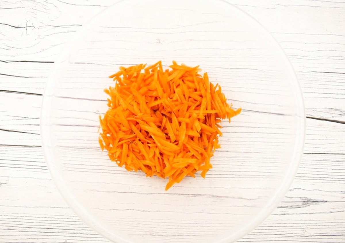 Grated carrot in a mixing bowl.