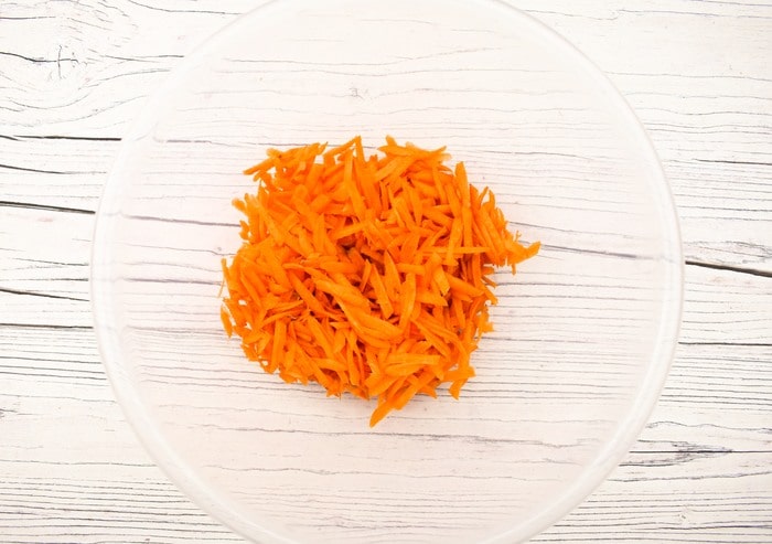 Grated carrot in a mixing bowl.
