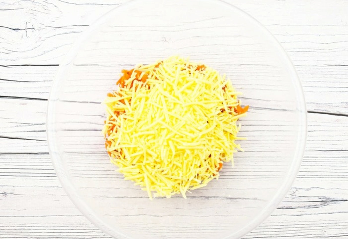 Cheese added to the bowl.