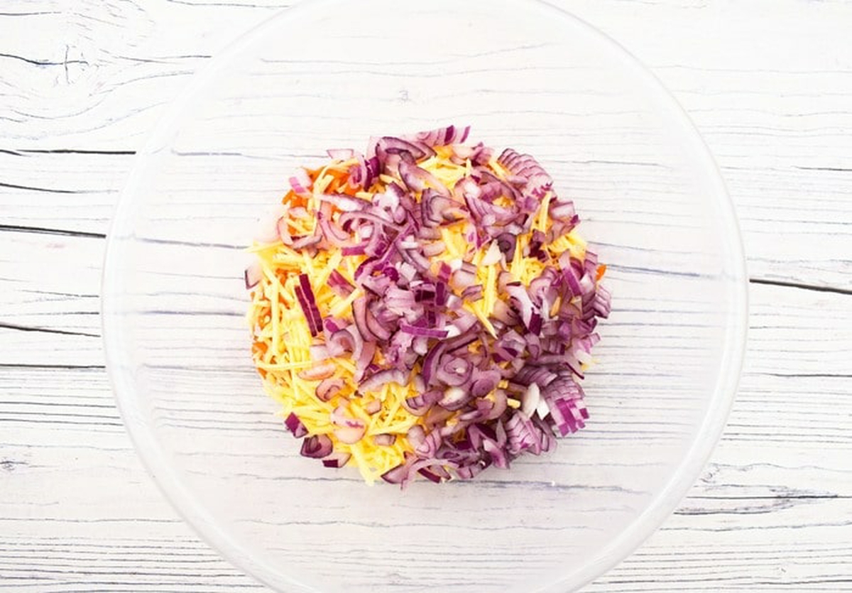 Chopped red onion added to the bowl.