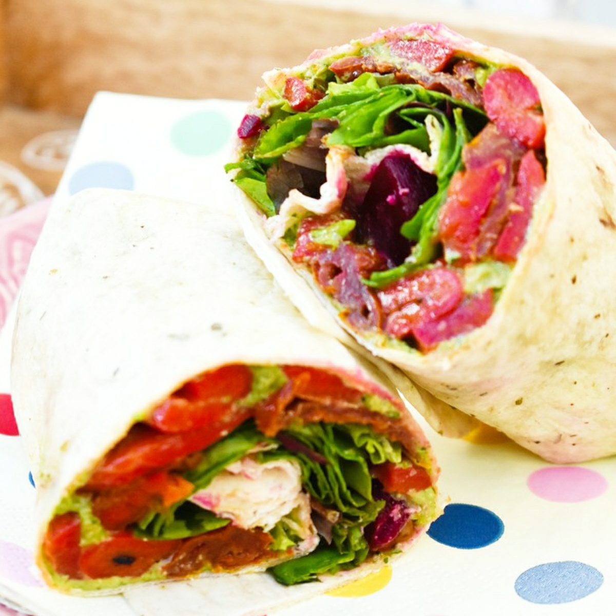 Vegan Kale and Red Pepper Wrap on a spotty napkin.