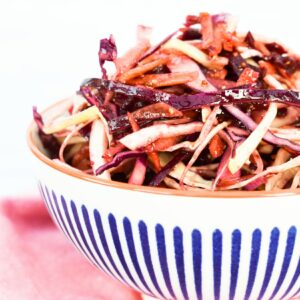 Balsamic beet slaw in a stripy bowl.