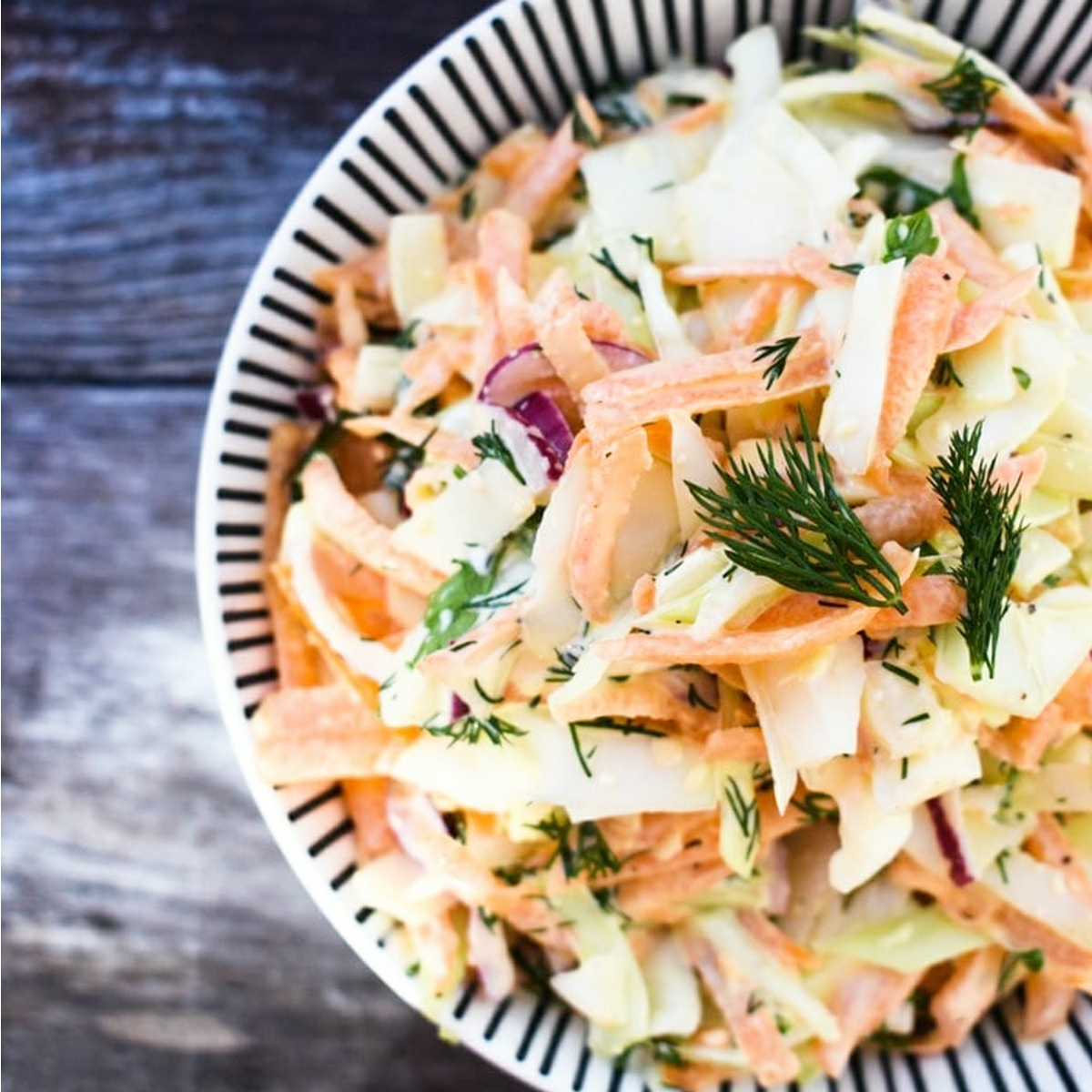 Vegan carrot and dill slaw in a bowl.