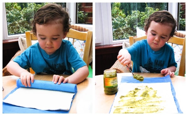 Step one - roll out puff pastry and spread pest.