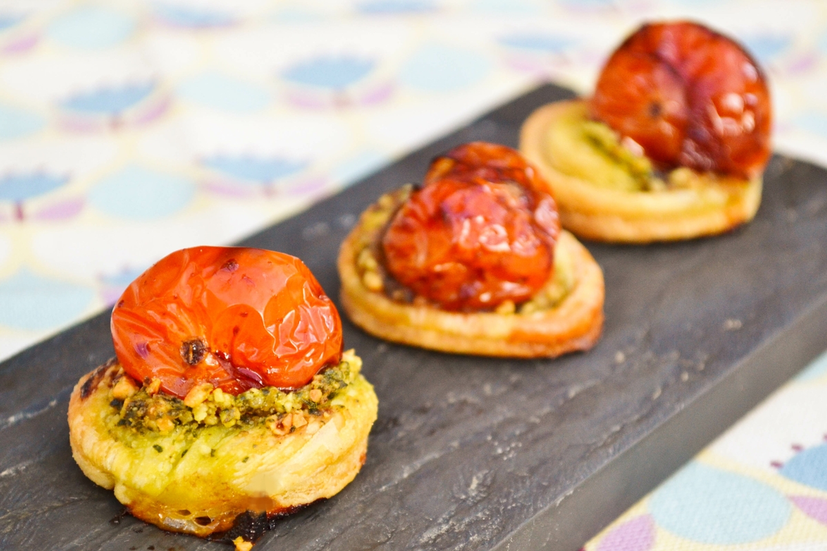 final golden baked tomato pastry bites in a slate board,