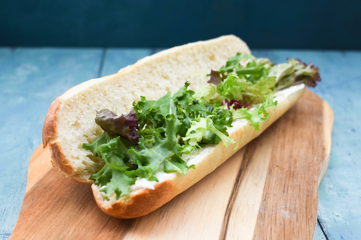 British cheese plpughman's sandwich -step 1 - spread bread with butter or mayo and top with salad leaves,