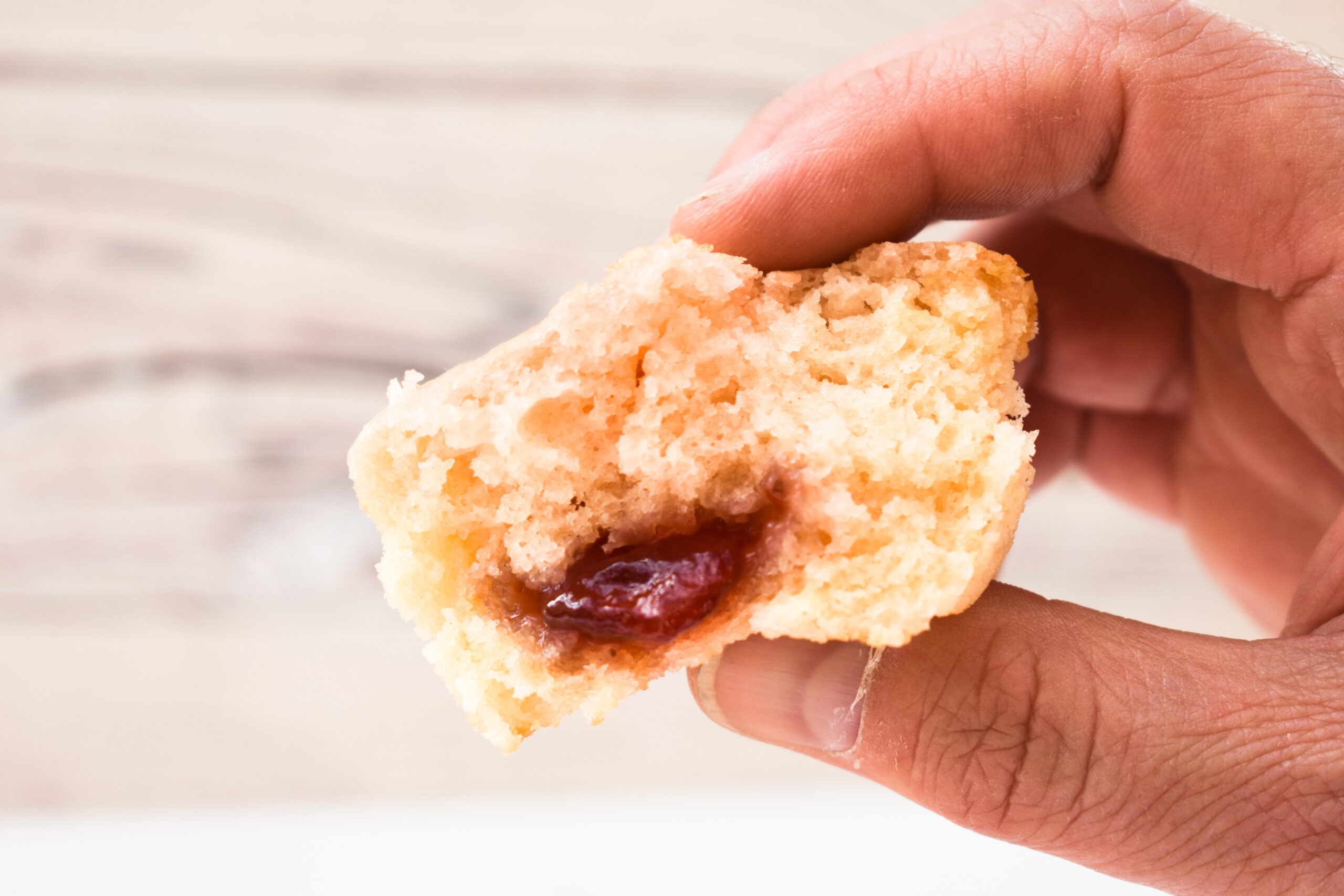 half muffin showing jam inside.