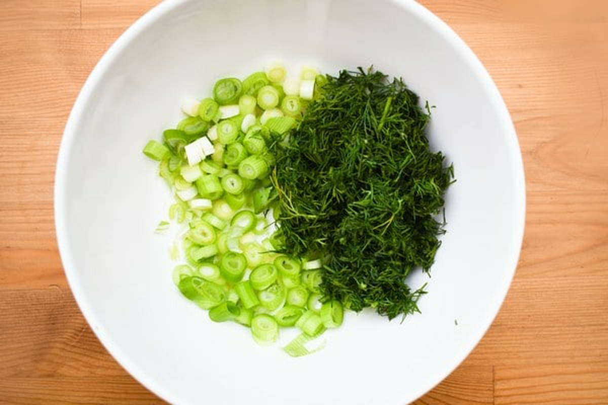 Fresh herbs added to bowl.