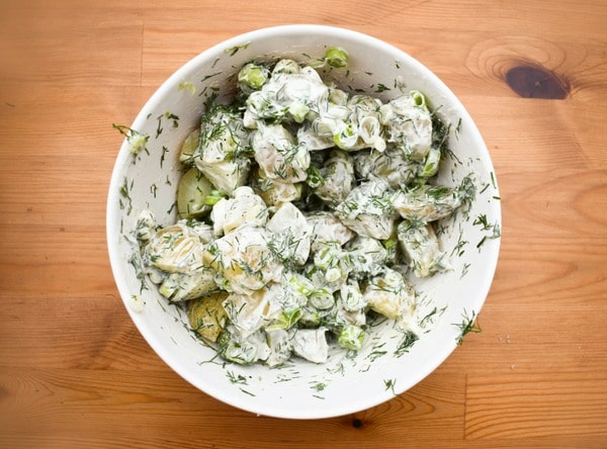Potatoes mixed with all ingredients and dressing.
