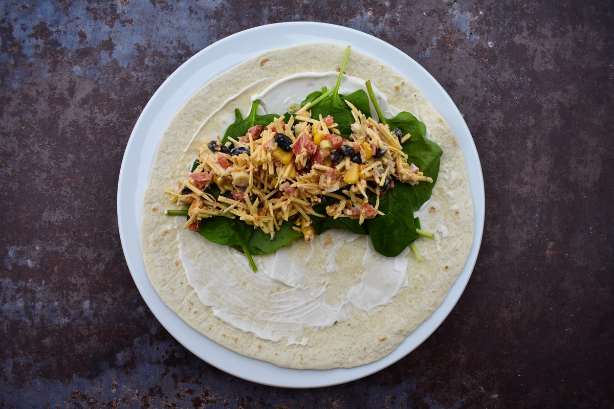Tex Mex Cheese Crunch Wrap - step 4 - spread mayo on tortilla, top with spinach and bean mixture.