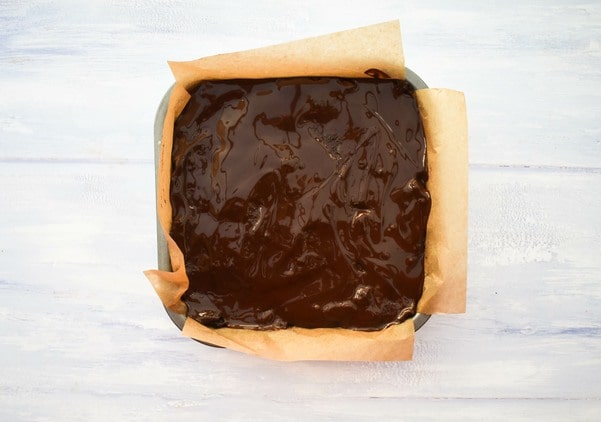 melted chocolate poured over tiffin.