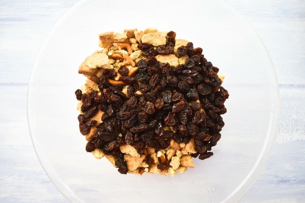 crushed biscuit and pretzel in a bowl with raisins.
