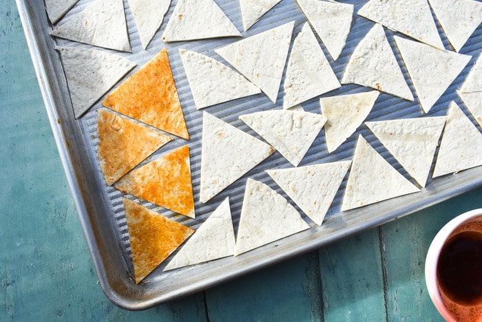 making paprika tortilla chips - step 3 - brush the chips.