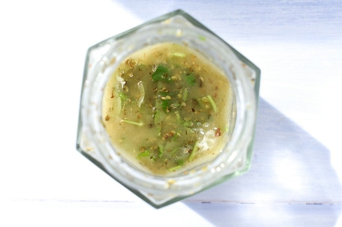 Herbs, mustard and seasoning added to salad dressing.