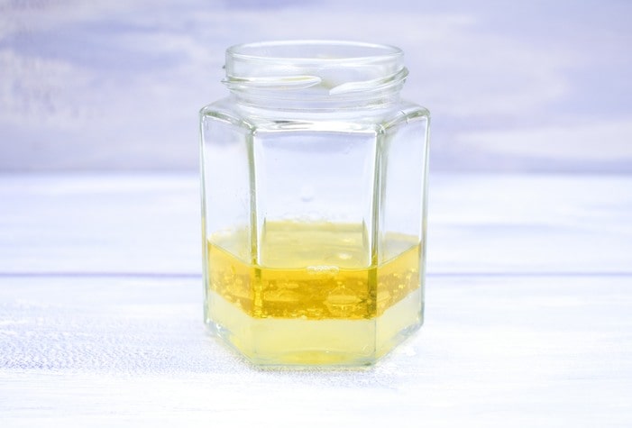 Oil, lemon juice and vinegar in a jam jar.