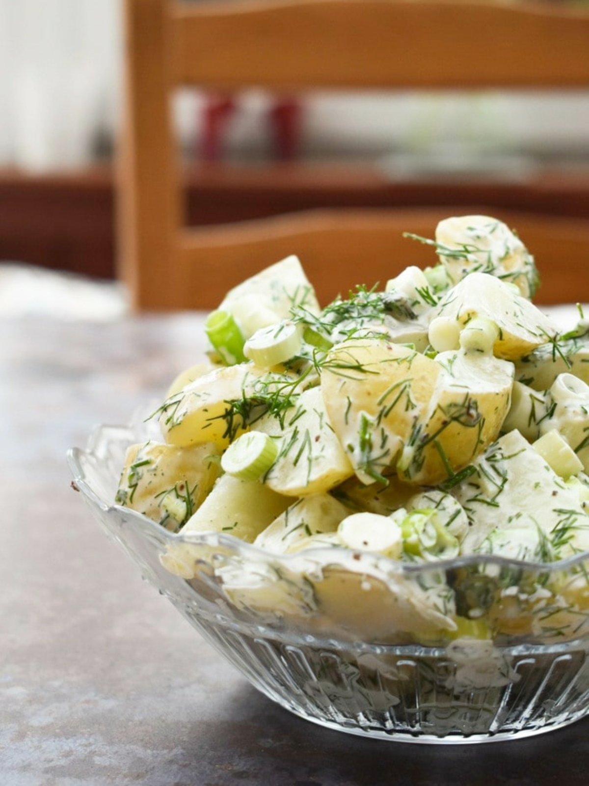 Vegan dill potato salad in a glass bowl.