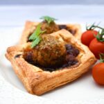 A square falafel onion pie with cherry tomatoes
