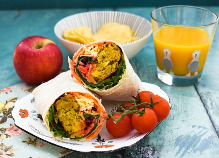 Onion Bhaji Lunch Wrap served with cherry .tomatoes.