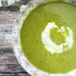 Vegan broccoili and pea soup with a swirl of cream