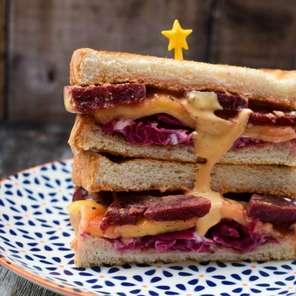 Vegan Reuben Sandwich with Russian Dressing on a patterned plate