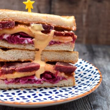 Reuben Sandwich stacked on a patterned plate