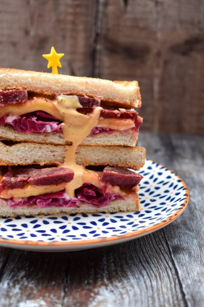 Reuben Sandwich stacked on a patterned plate