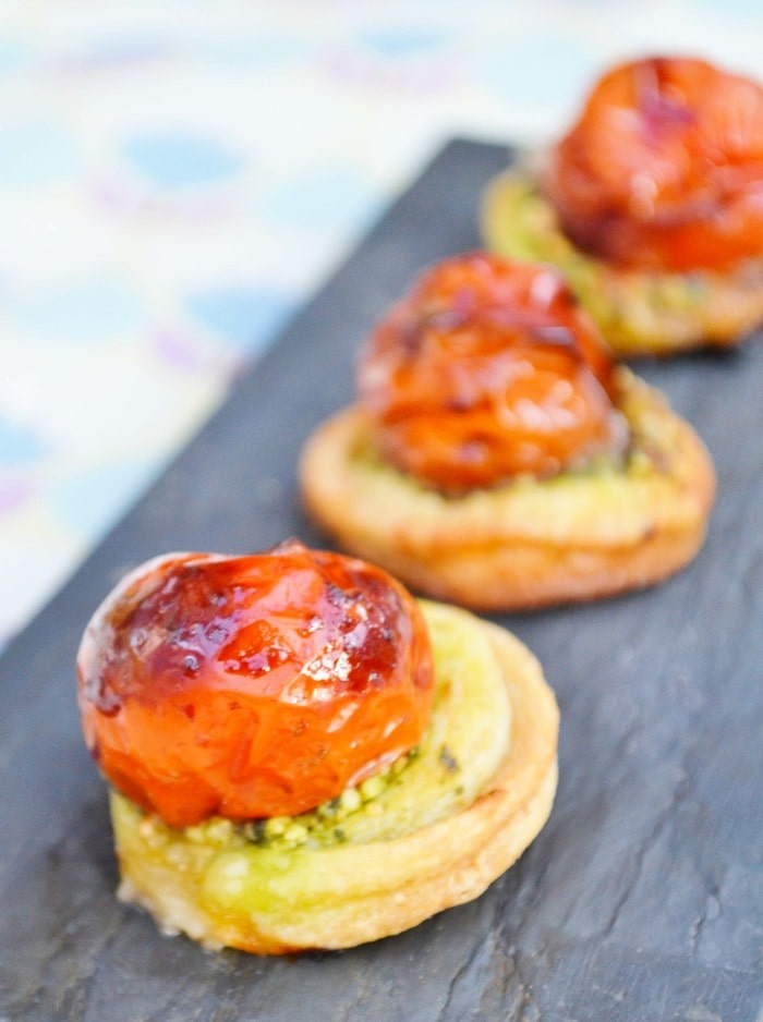 Slate board with bite-sized vegan tomato pastry bites.