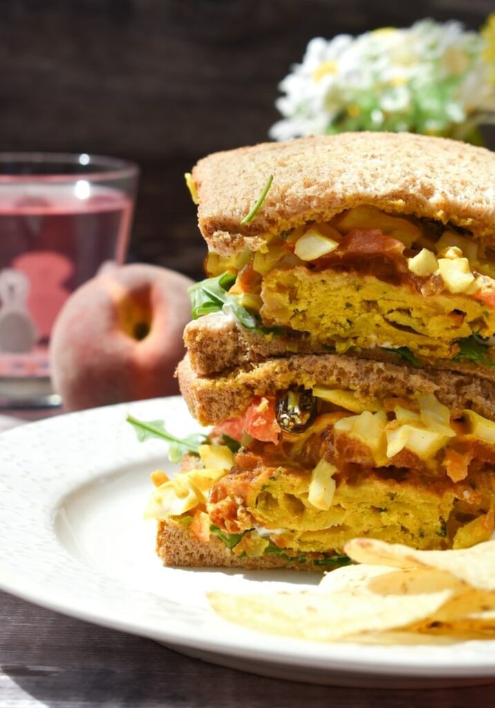 onion bhaji sandwich stacked on a plate 