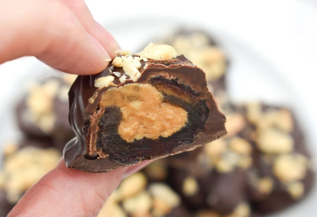 Half a vegan Snickers bar showing the filling
