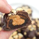 Half a vegan Snickers bar showing the filling