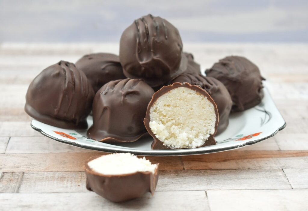 Vegan coconut bounty bites, one cut open to show the filling