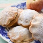 Easy Individual Shortcrust Apple Pies on a floral tea plate with an apple.