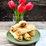 Vegan Butternut Squash and Chickpea Parcels stacked on a plate.