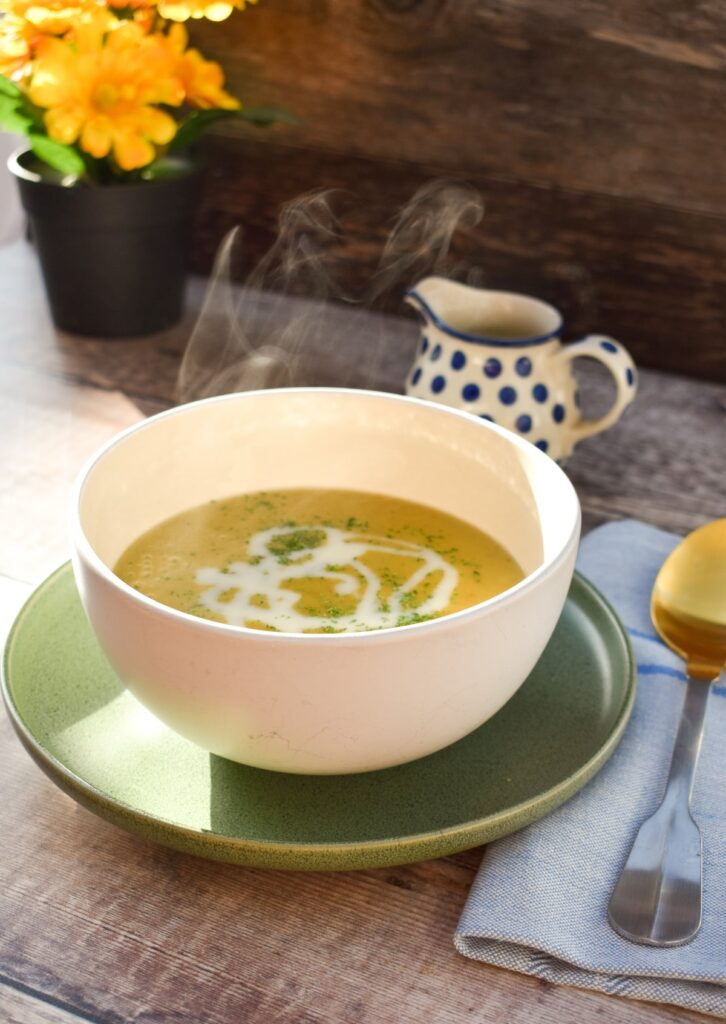 vegan jacket potato soup in a bowl, giving off steam as it is so hot).