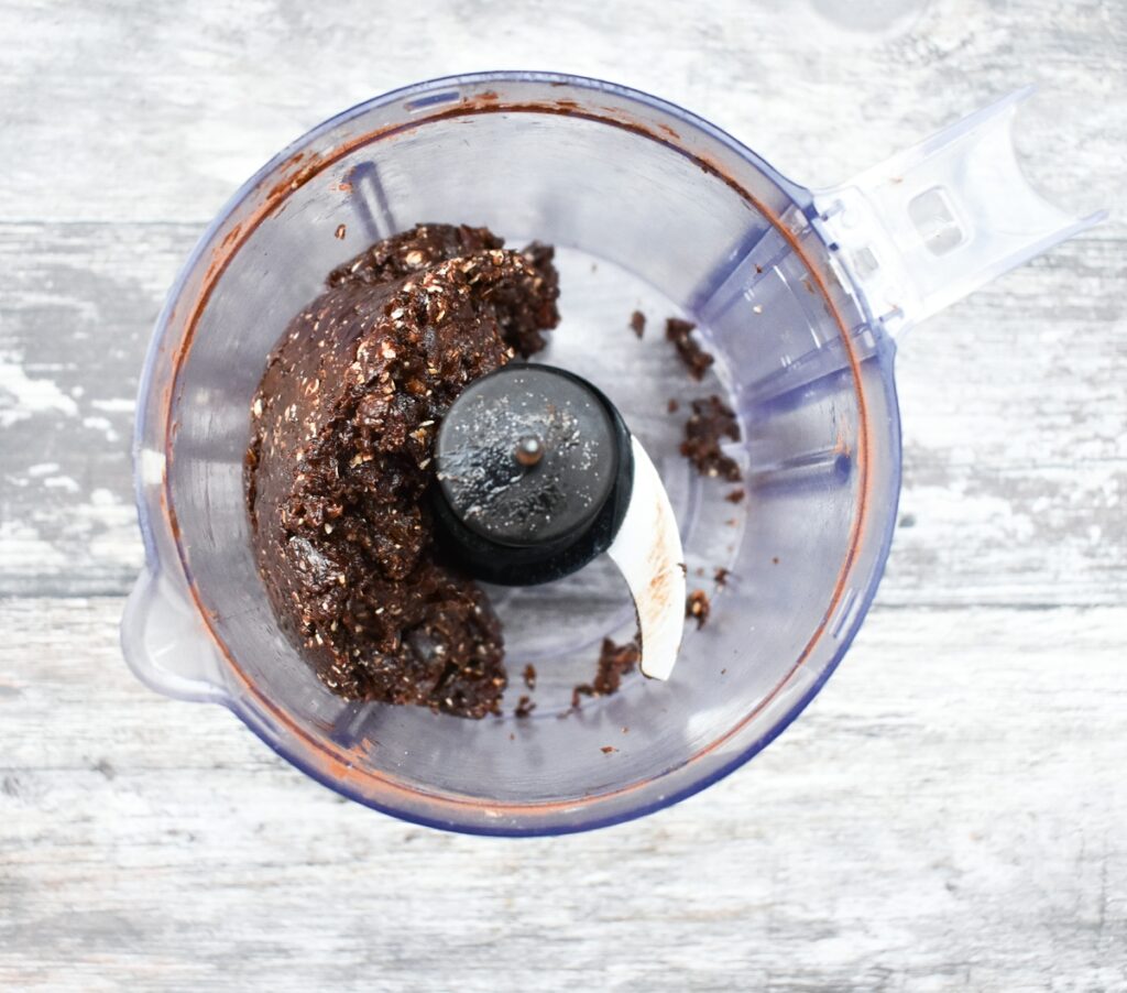 vegan no-bake brownie dough in a mini food processor jug.