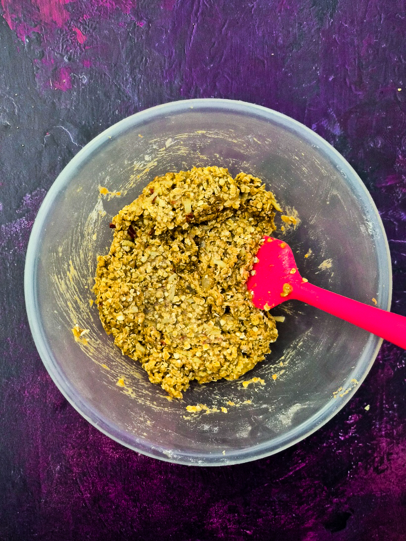 Melted butter mixture combined with dry flapjack mixed in a mixing bowl.