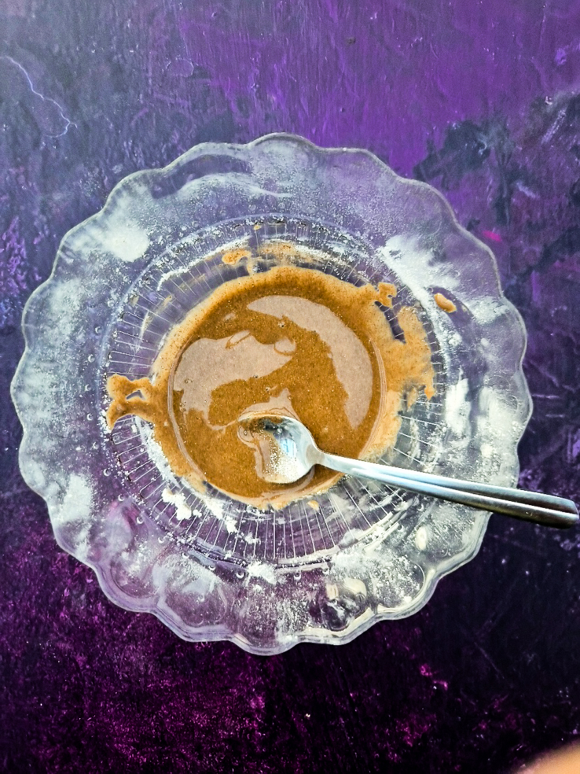 Icing sugar (confectioner's sugar), cinnamon and water mixed in a bowl to make cinnamon icing.