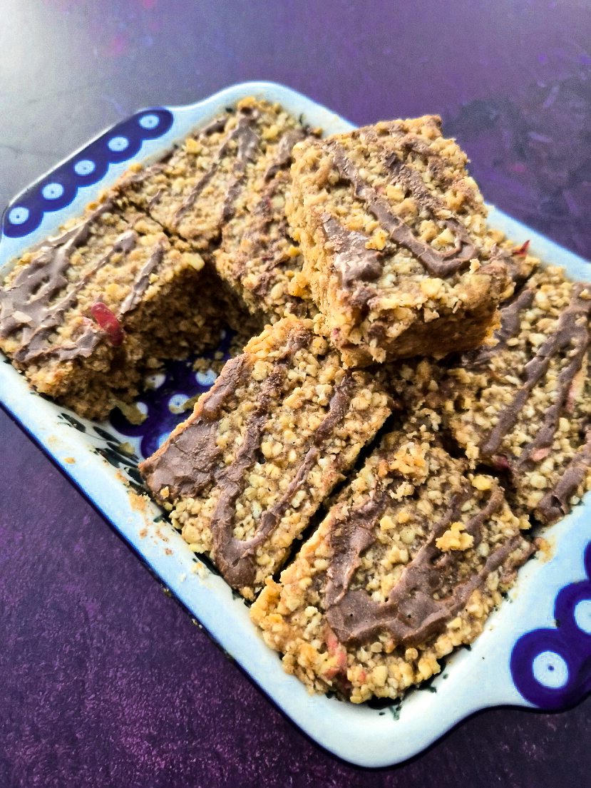 Cool flapjacks cut into bars and drizzled with cinnamon icing.
