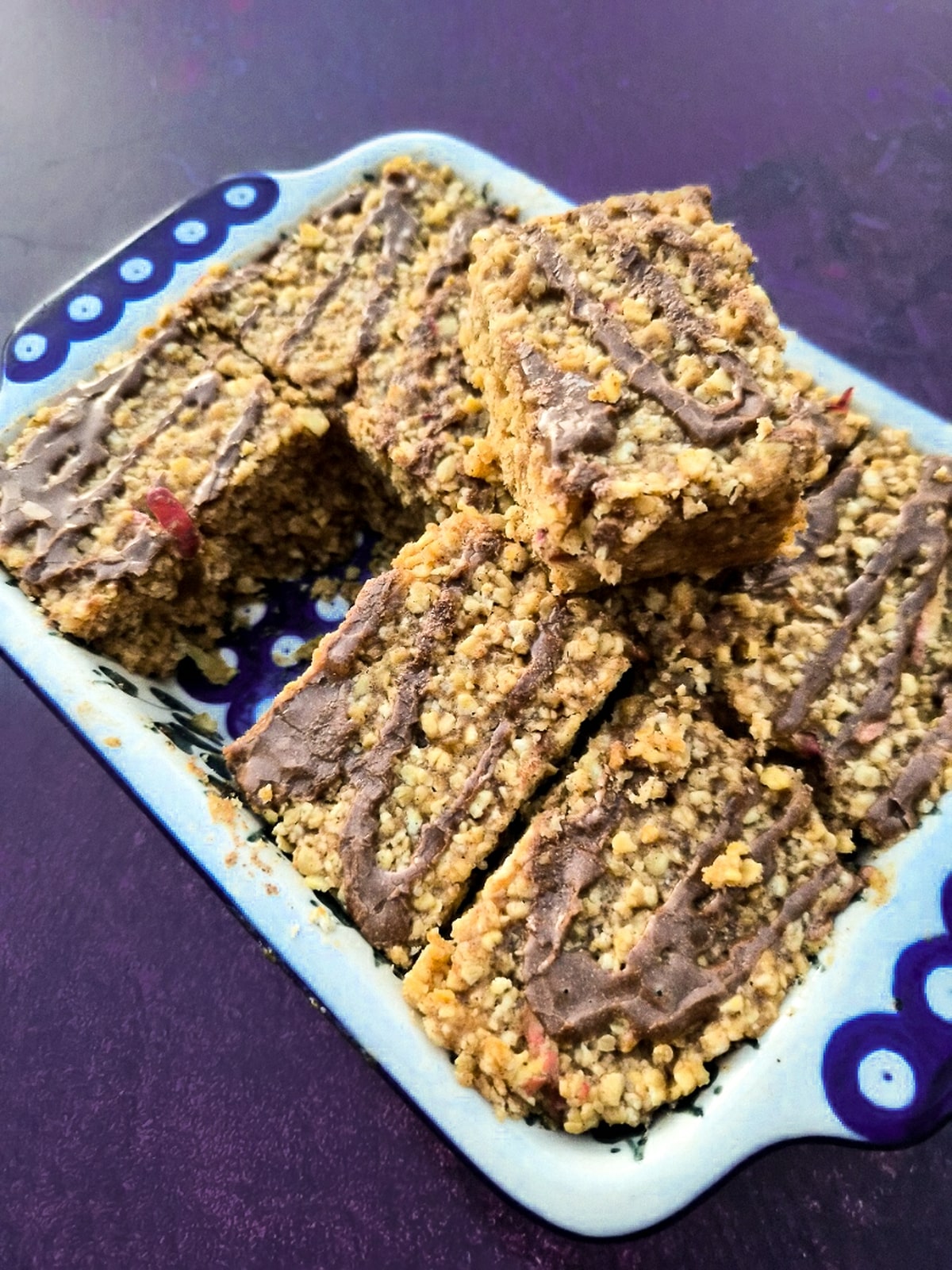 apple and cinnamon flapjacks in a blue and white ceramic dish but into bars.